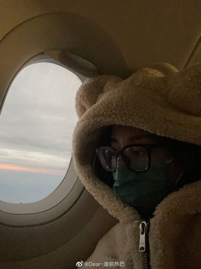 迪丽热巴分享飞机上小熊衣服，对着镜头比耶超可爱
